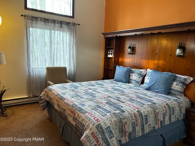 a bedroom with bed and window