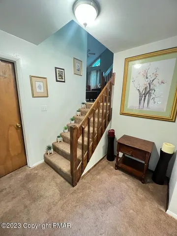 a view of staircase with furniture and stairs