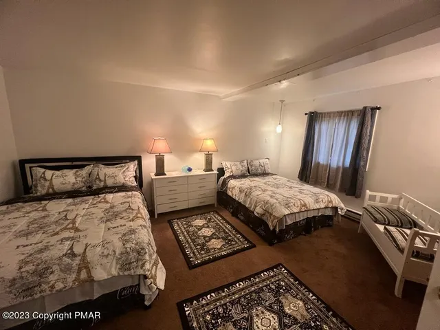 a bedroom with double bed and a night stand