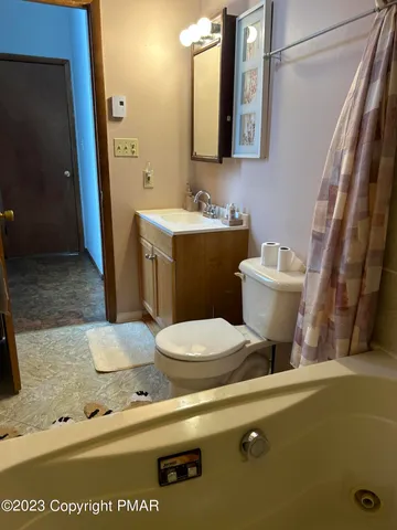 a bathroom with a toilet sink and mirror