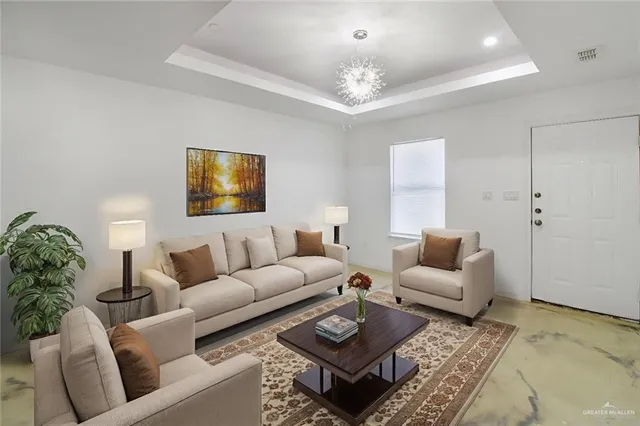 a living room with furniture a chandelier and a flat screen tv