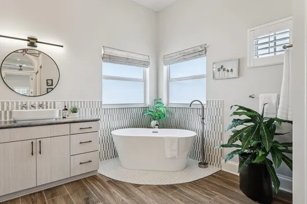 a bathroom with a granite countertop sink a toilet and a mirror