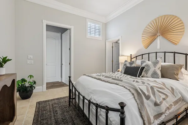 a bed sitting in a bedroom next to a window