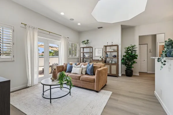 a living room with furniture and a large window