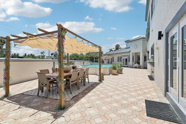 a view of a patio with a table and chairs and potted plants