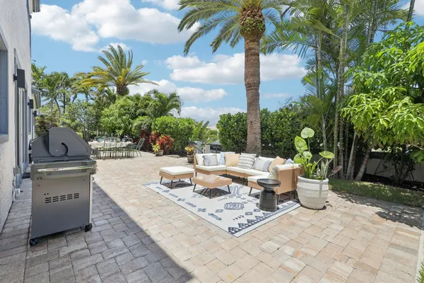a view of a backyard with furniture and a garden