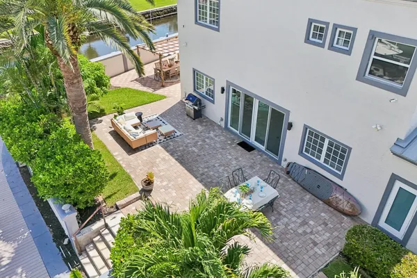 a view of a swimming pool with outdoor seating and a garden
