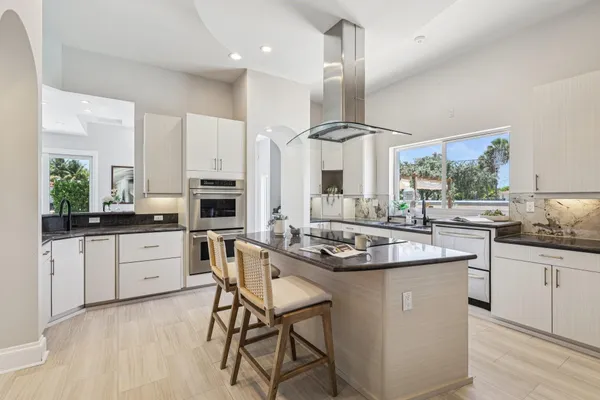 a kitchen with stainless steel appliances kitchen island granite countertop a sink and cabinets