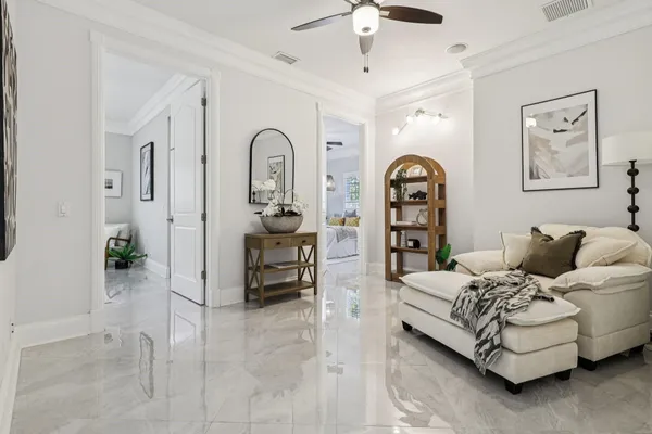 a spacious bedroom with a bed couch and painting on the wall