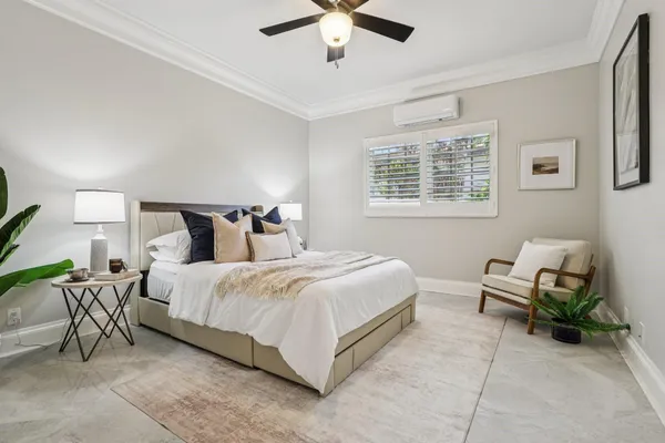 a bedroom with bed and a chandelier