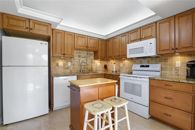 a kitchen with a refrigerator a sink and cabinets