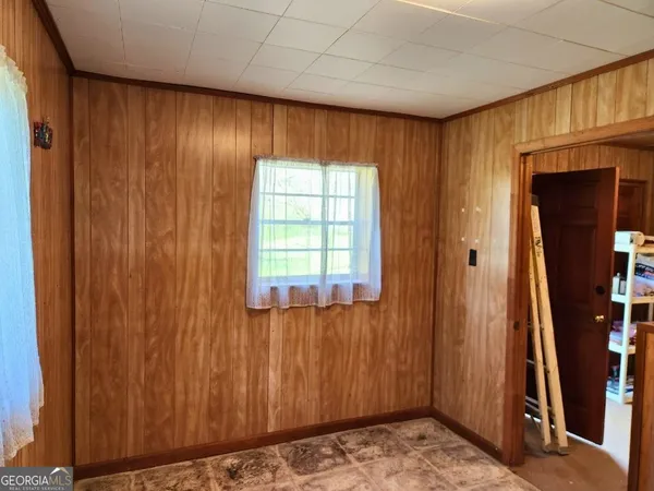 a living room with furniture a flat screen tv and couches