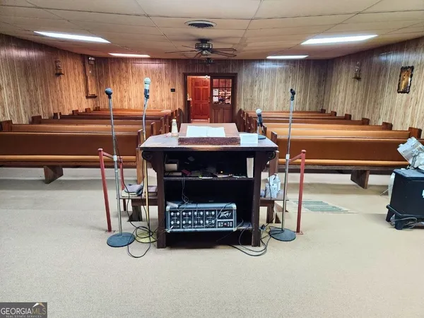 a living room with furniture a pool table and a fireplace