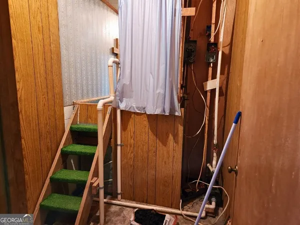 a view of a livingroom with wooden floor and a ceiling fan