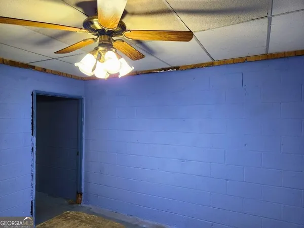 a view of walk in closet with window and a chandelier