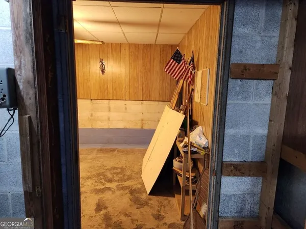 a view of hallway with wooden floor and stairs