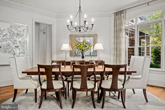 a view of a dining room with furniture and chandelier