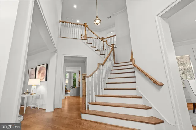 a view of entryway and hall with wooden floor