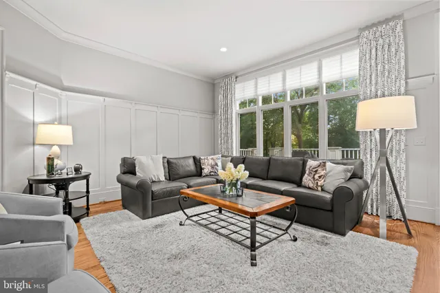 a living room with furniture and a lamp