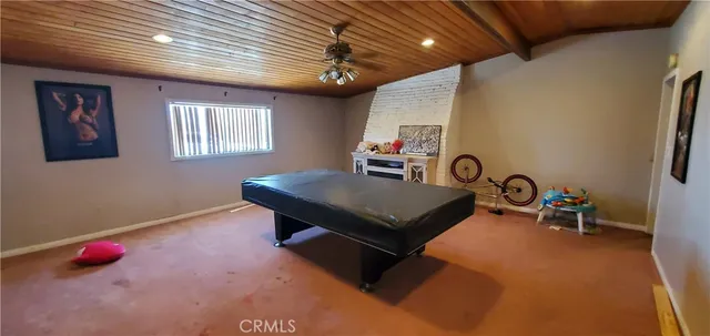 a living room with pool table and furniture