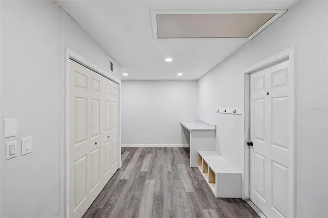 a view of hallway with wooden floor