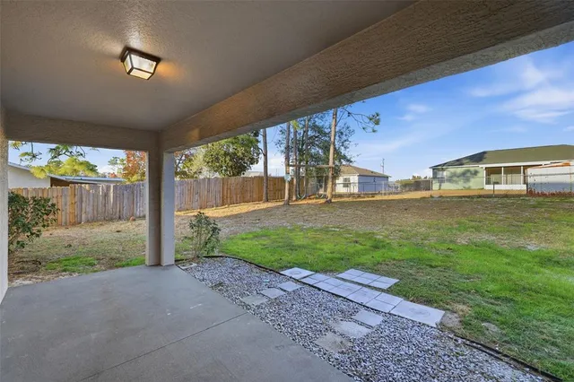 a view of a house with backyard and porch