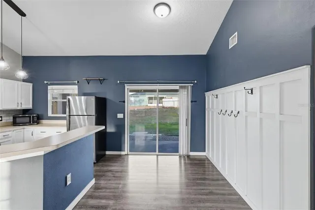 a large kitchen with a large window and stainless steel appliances