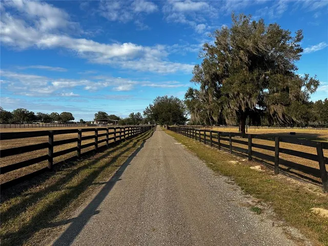 a view of a street with wooden fence