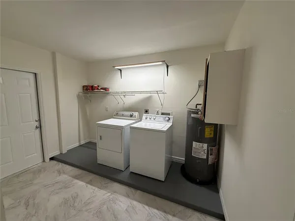 a view of a hallway with washer and dryer
