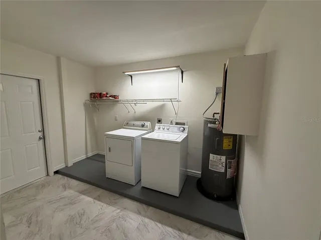 a view of a hallway with washer and dryer
