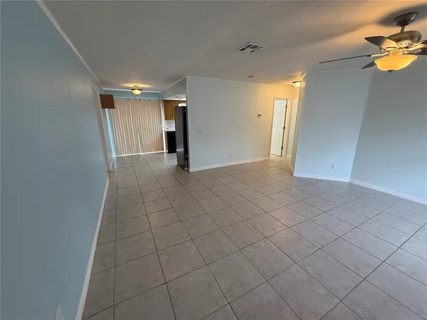 a view of an empty room and a window