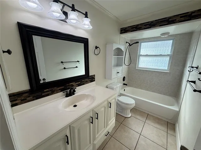 a bathroom with a double vanity sink a toilet and a mirror
