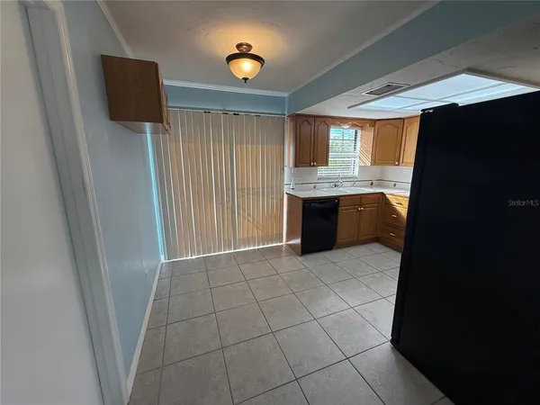 a kitchen with granite countertop a refrigerator and a sink