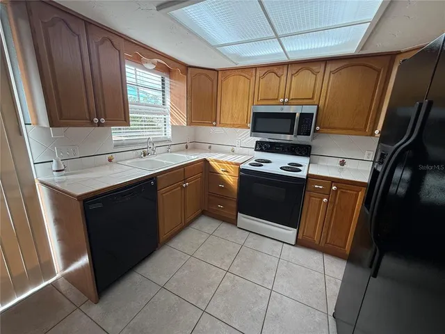 a kitchen with a stove a sink and a microwave