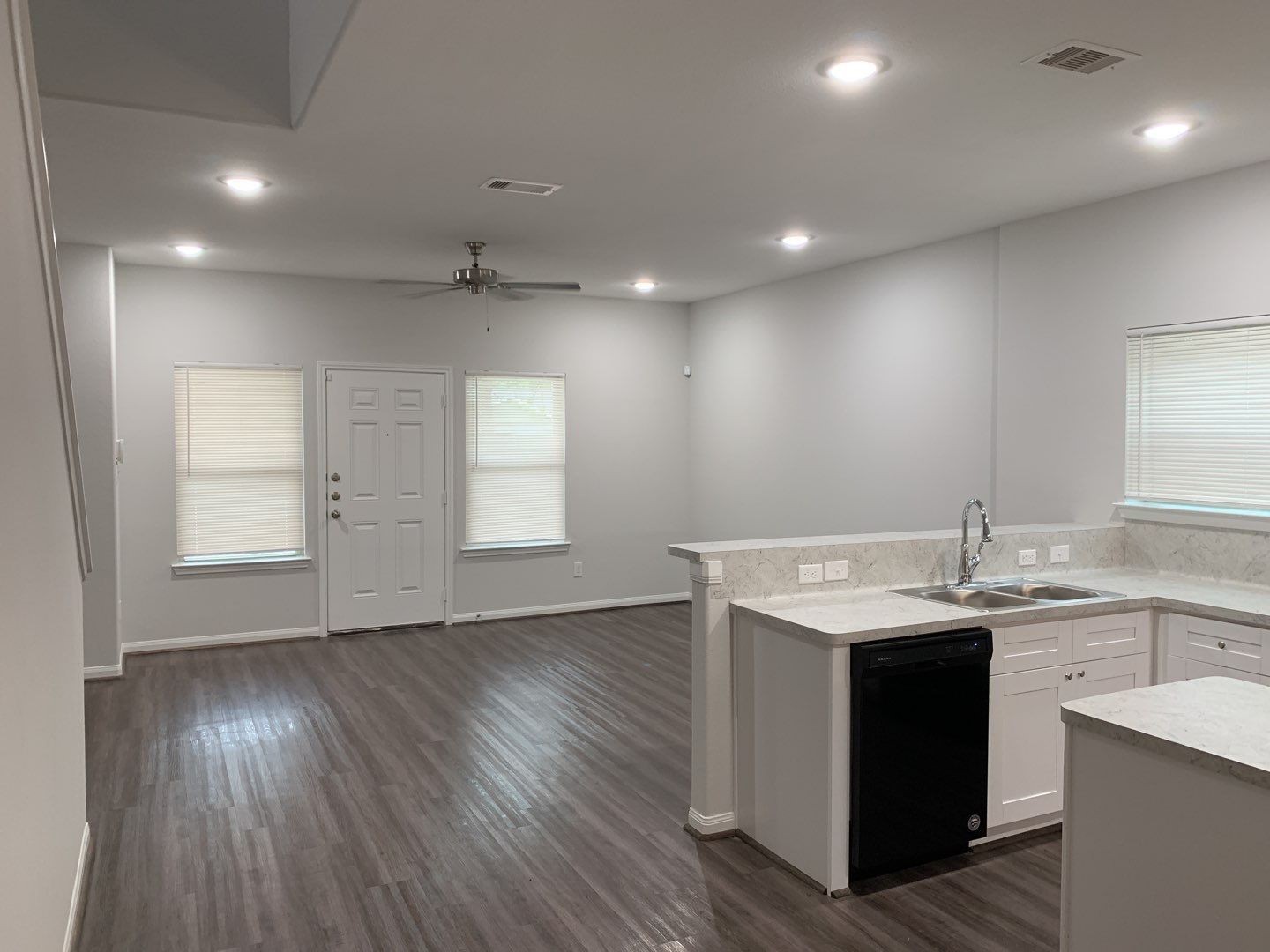 7966 Henson Street, Unit B Houston, TX 77028 - Photo 2 of 27 a kitchen with a sink a wooden floor and a window