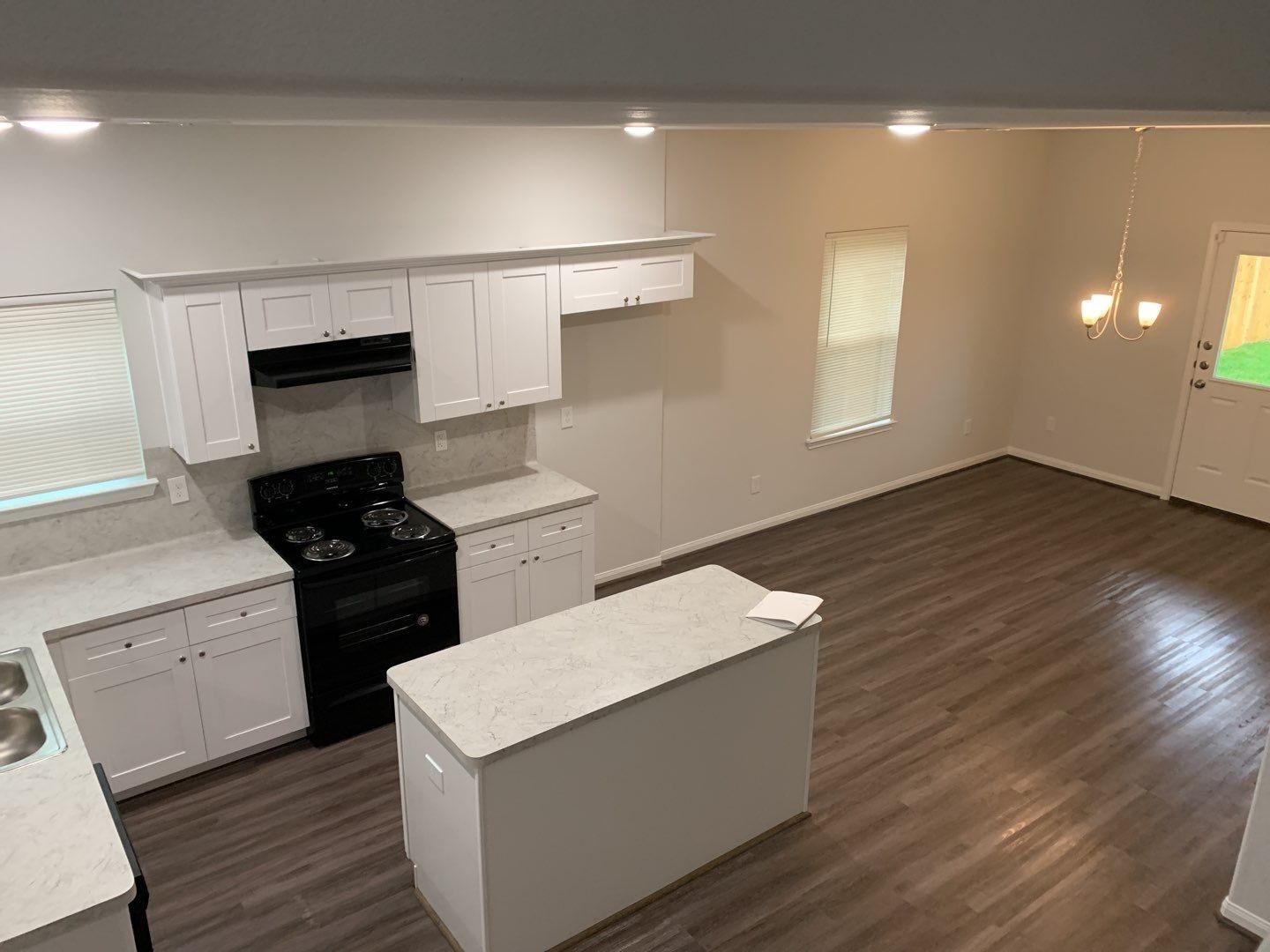 7966 Henson Street, Unit B Houston, TX 77028 - Photo 4 of 27 a kitchen with granite countertop a stove and a refrigerator