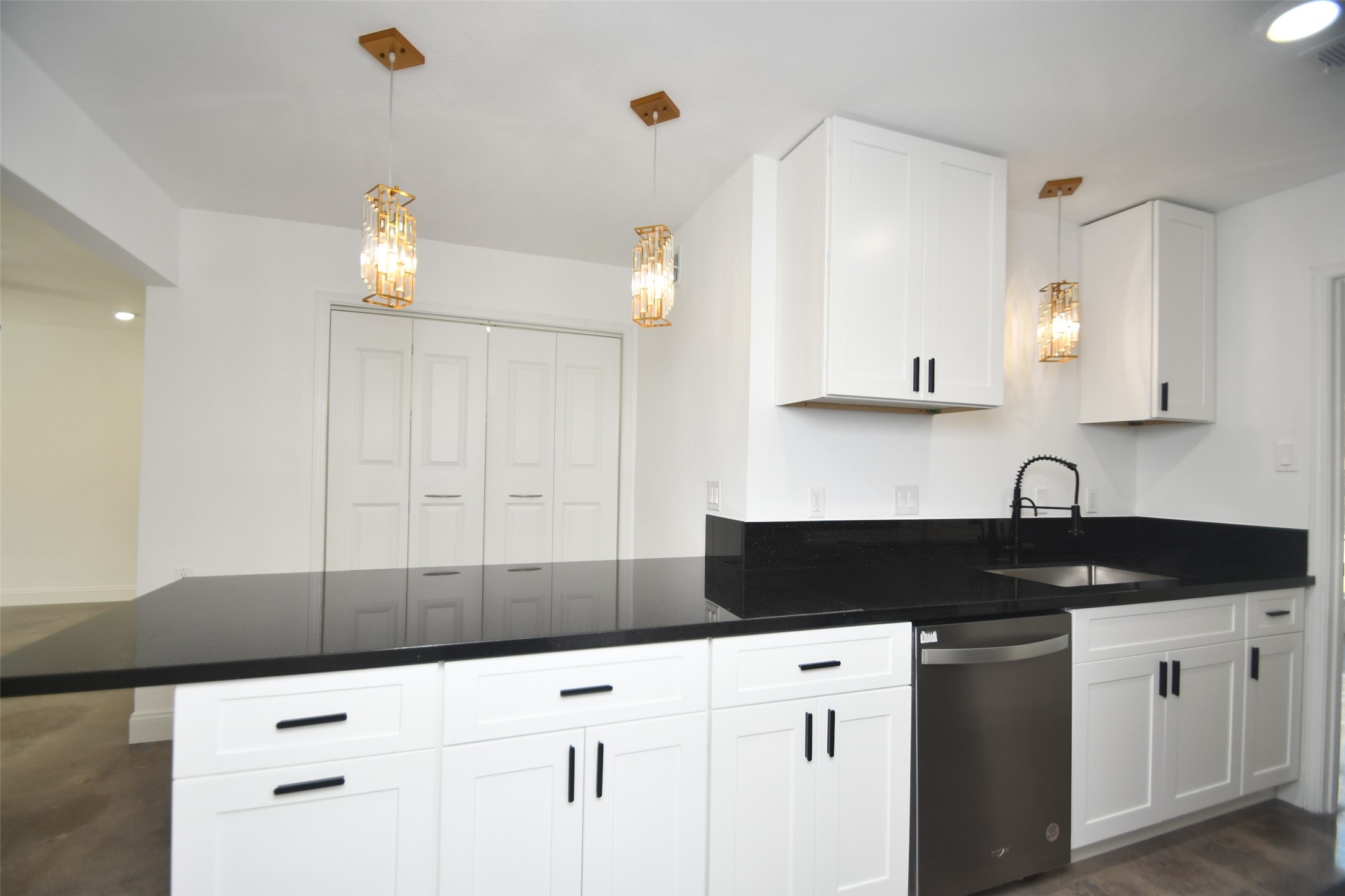 5801 Lumberdale Road, Unit 120 Houston, TX 77092 - Photo 14 of 45 a kitchen with granite countertop white cabinets and black appliances