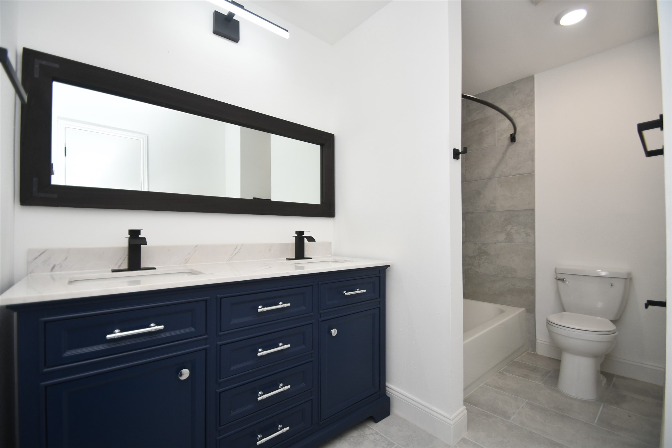 5801 Lumberdale Road, Unit 120 Houston, TX 77092 - Photo 29 of 45 a bathroom with a toilet sink double vanity and mirror
