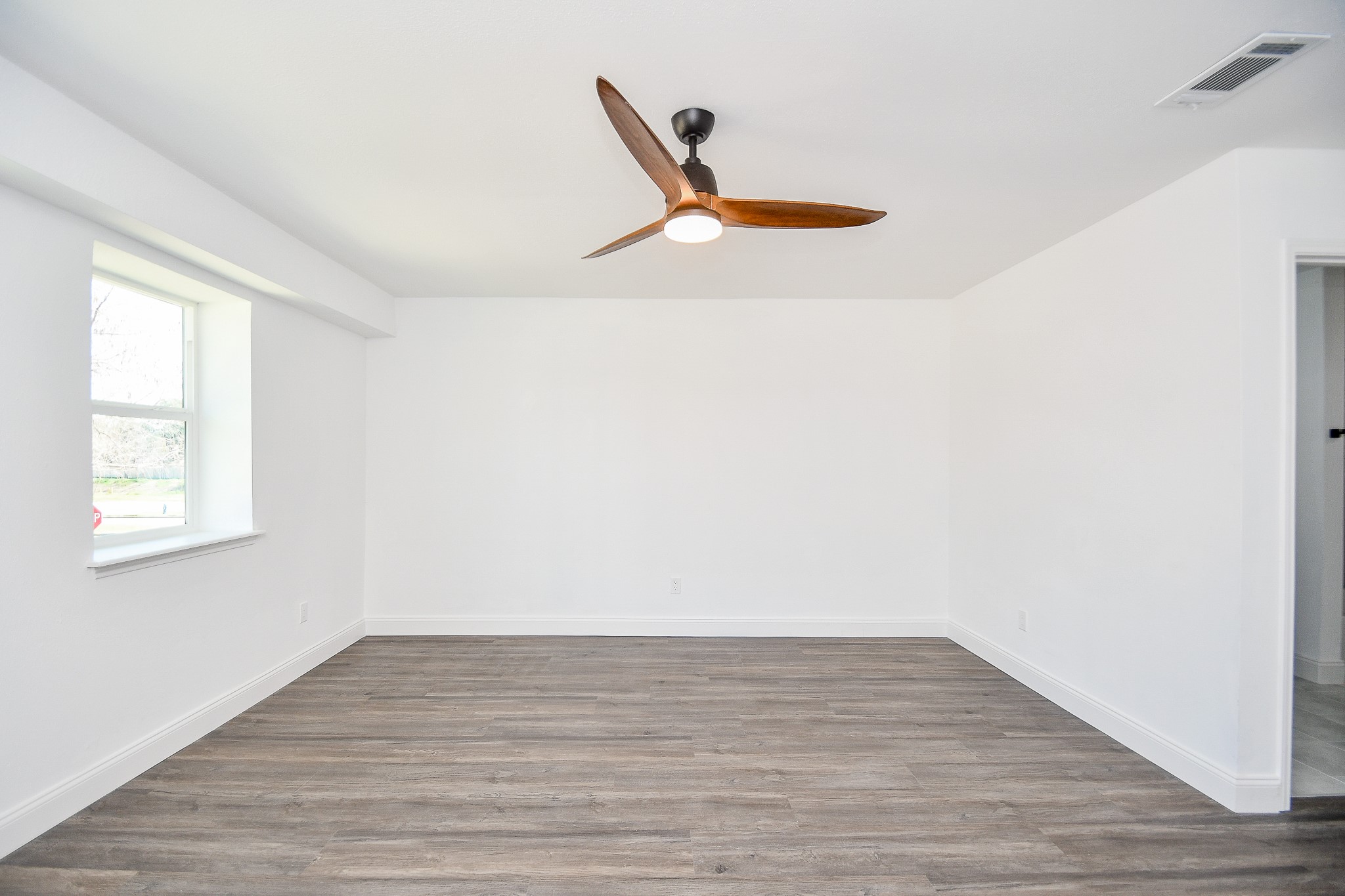 5801 Lumberdale Road, Unit 120 Houston, TX 77092 - Photo 34 of 45 a view of an empty room with wooden floor and a window