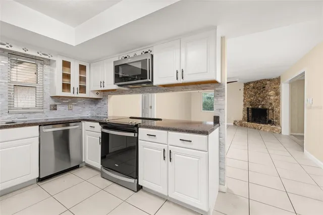 an empty room with wooden floor closet and fan