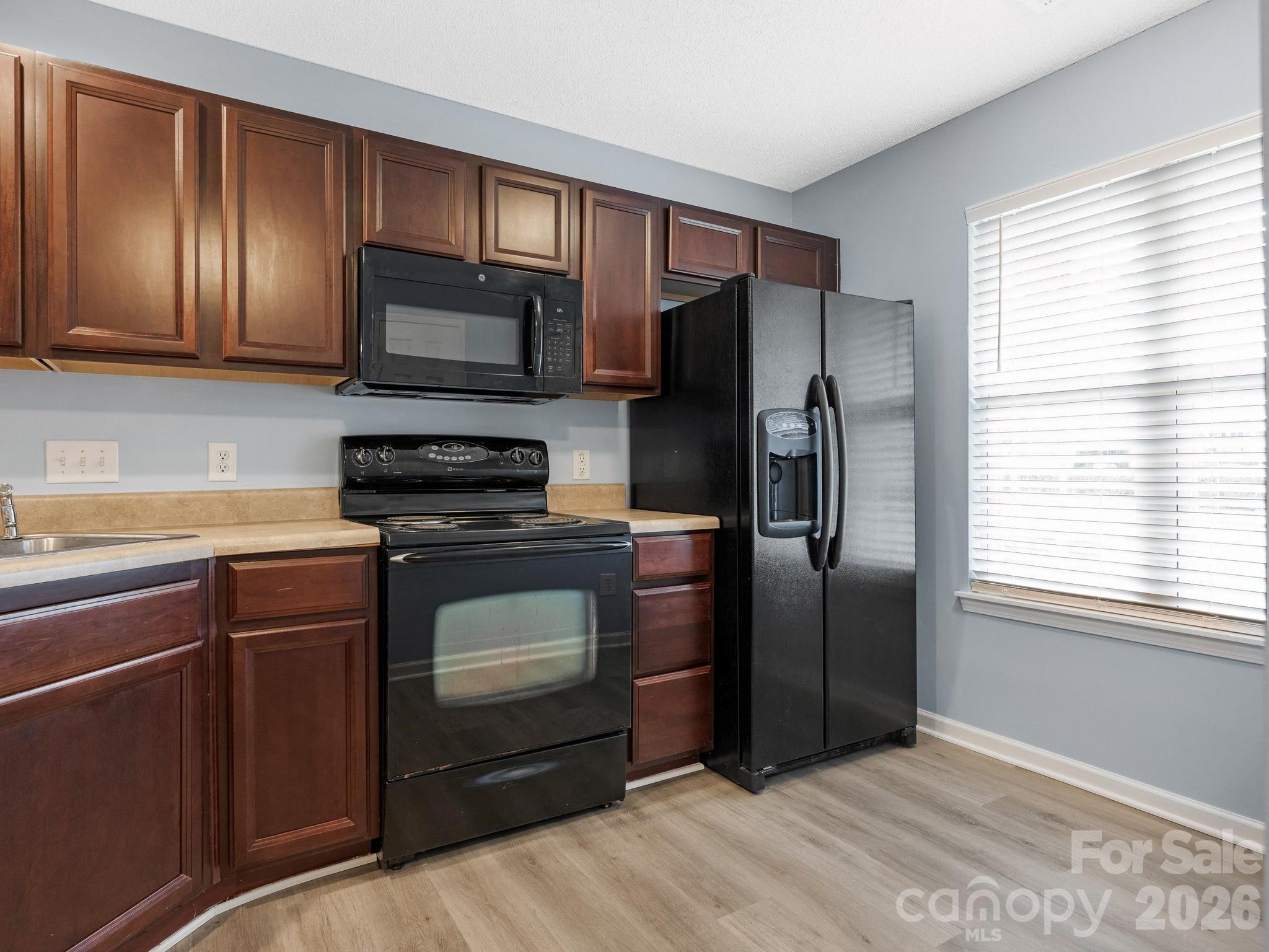 3259 Blythe Ridge Court Charlotte, NC 28213 - Photo 6 of 17 a kitchen with granite countertop stainless steel appliances a refrigerator stove and microwave