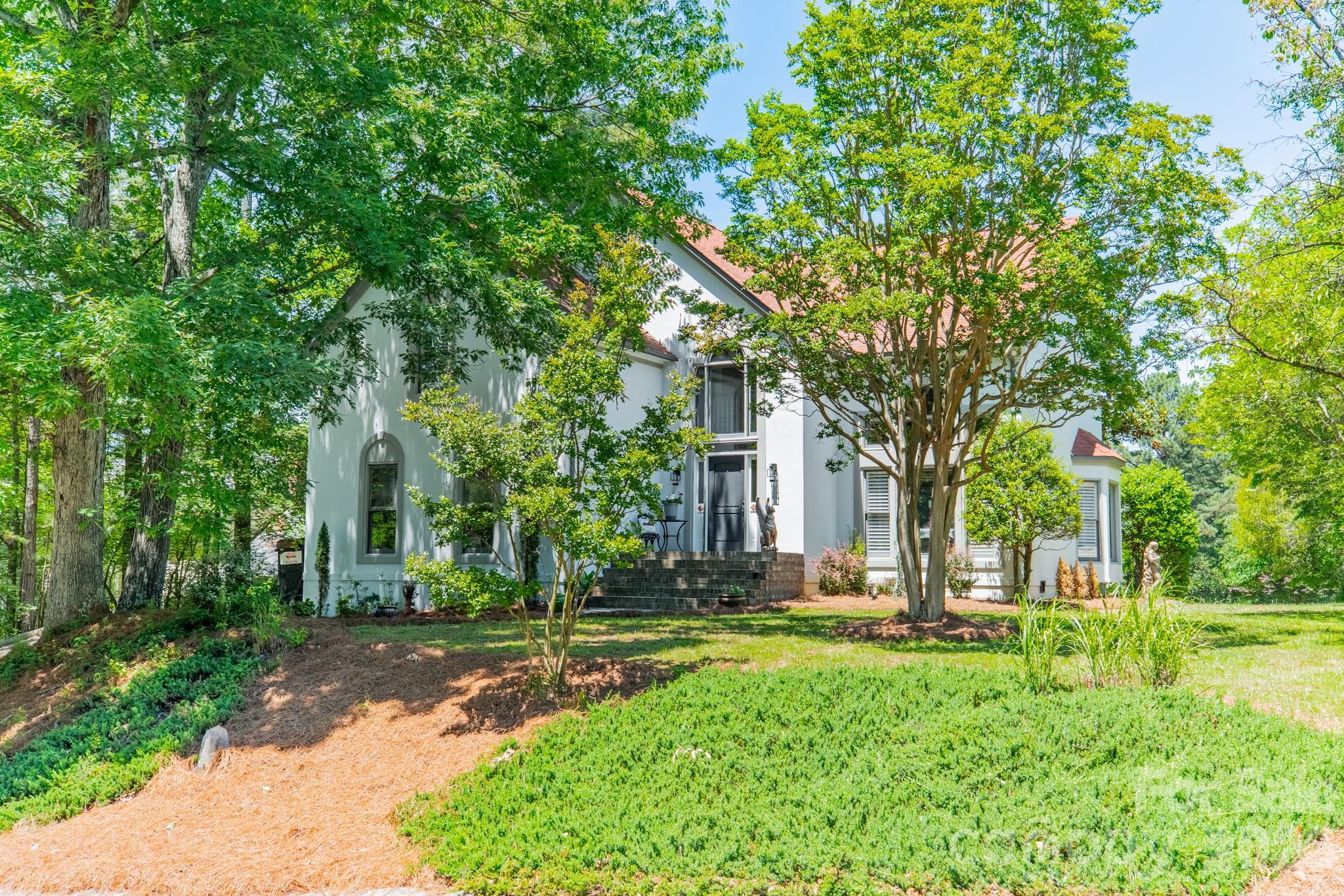 11043 Seven Coves Drive Tega Cay, SC 29708 - Photo 12 of 45 a backyard of a house with lots of green space and fountain