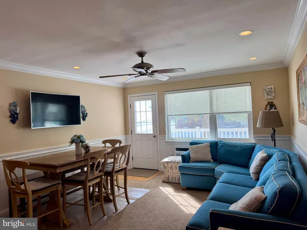 a living room with furniture a large window and a flat screen tv