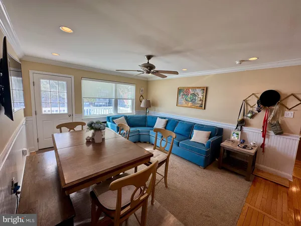 a view of a dining room with furniture and window
