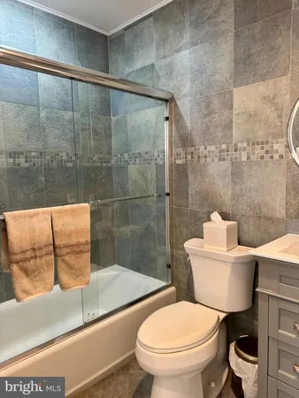 a bathroom with a toilet a sink and shower