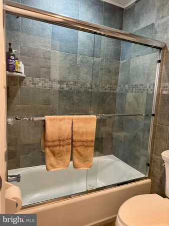 a bathroom with a shower and toilet
