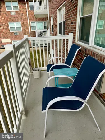 a front view of a house with balcony and stairs