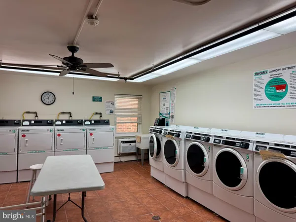 a kitchen with a stove a microwave and white cabinets