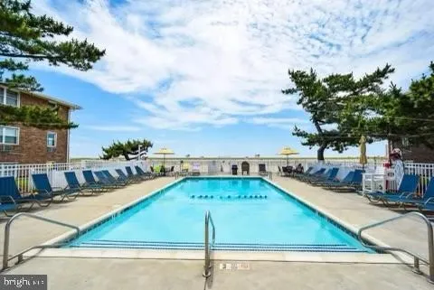 a view of a swimming pool with a lounge chairs