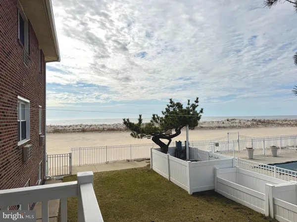 a view of a terrace with lawn chairs